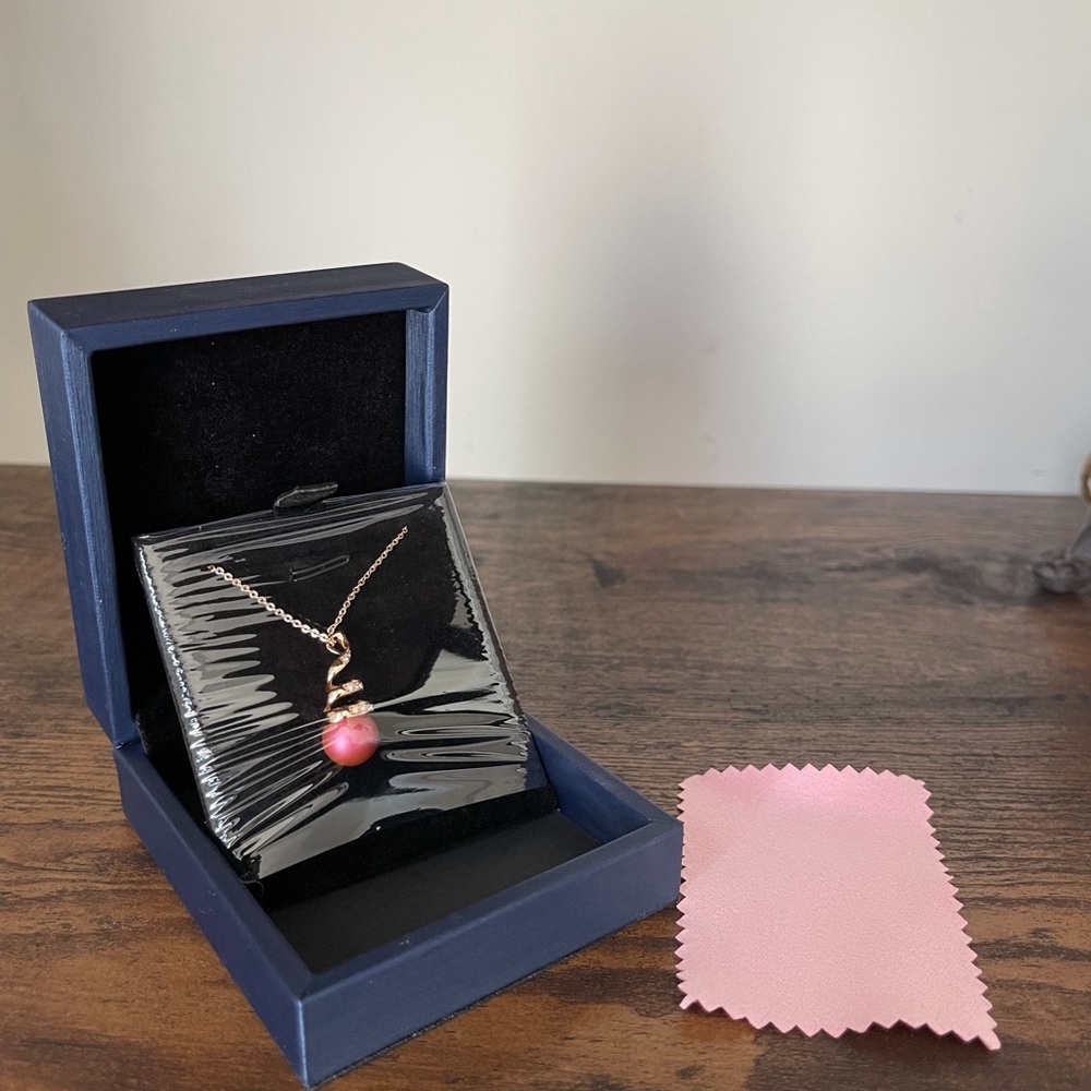 Cultured Burgundy Pearl with swirled rhinestone details on delicate chain.